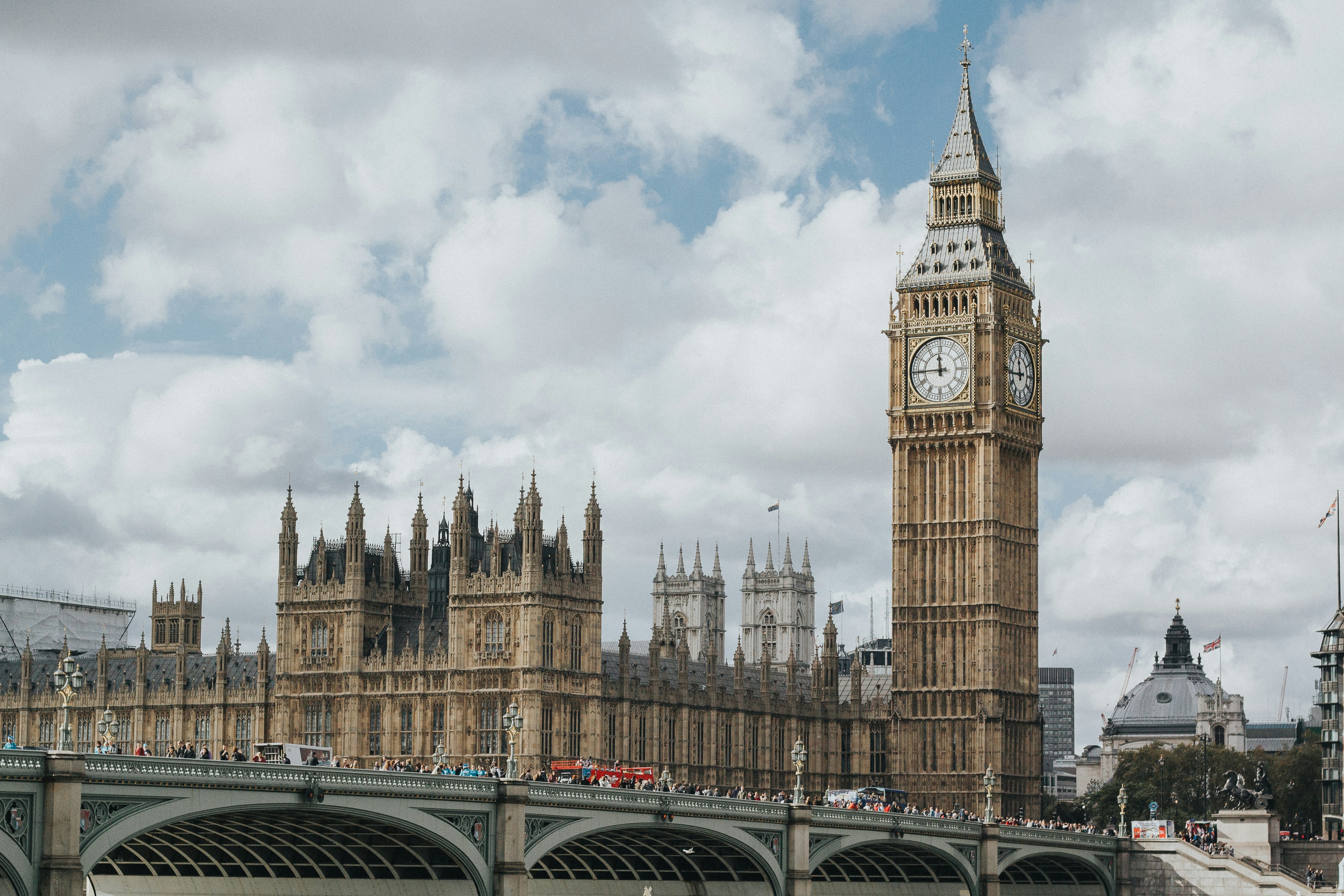 London Big Ben and Westminster Bridge with airplane overhead